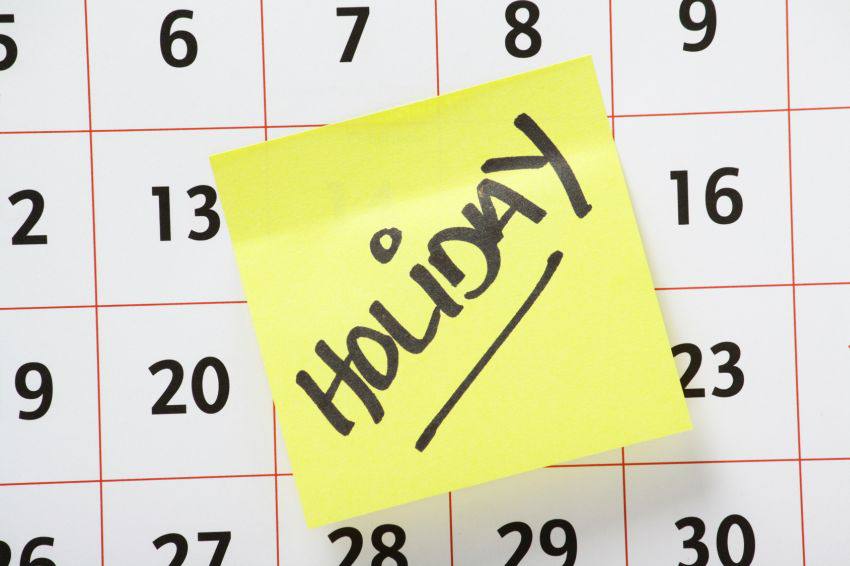 A calendar with a post-it written "Holiday" on it
