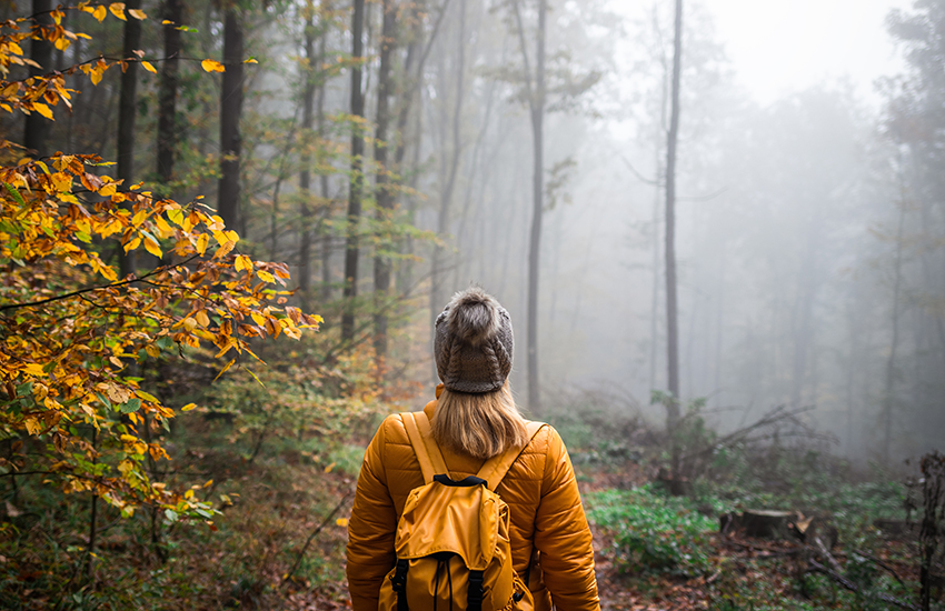Woman in woods in fall