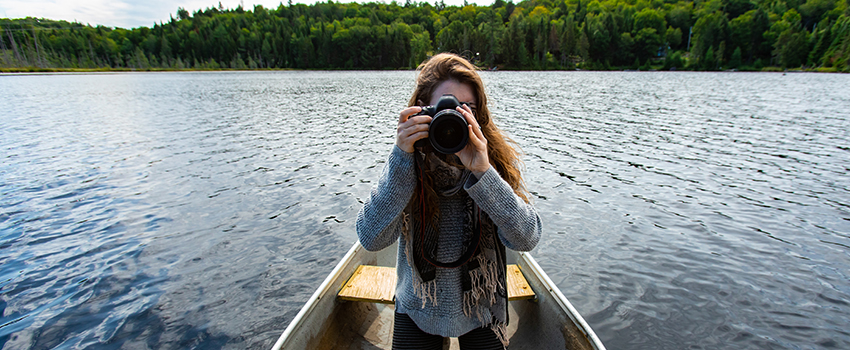 Lady in a boat with a camera