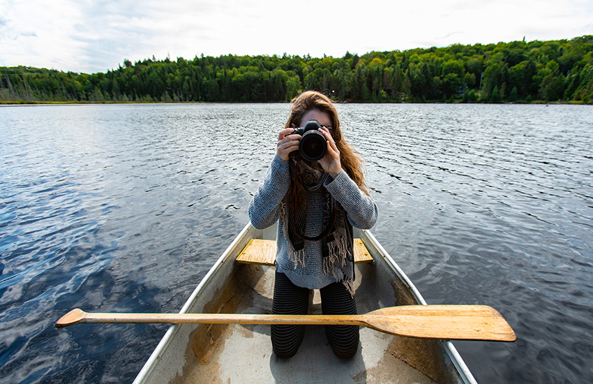 Lady in a boat with a camera