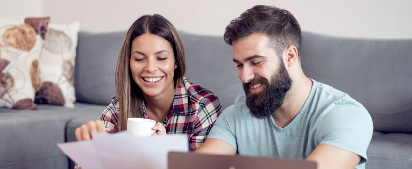 A couple looking at papers happily