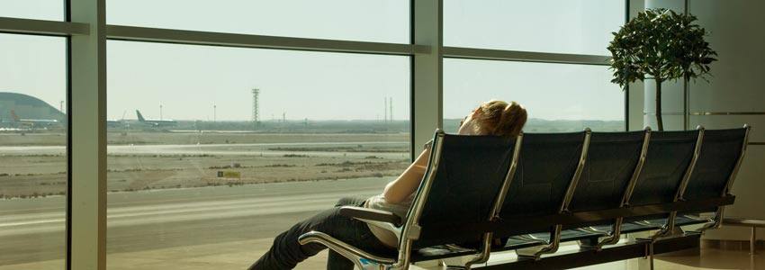 A woman sleeping on a chair at the airport