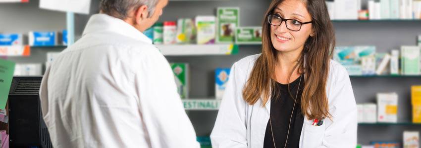 A pharmacist talking to a customer at the counter